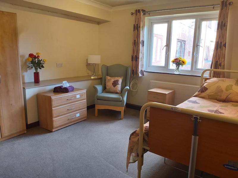 Bedroom at Moss View with armchair