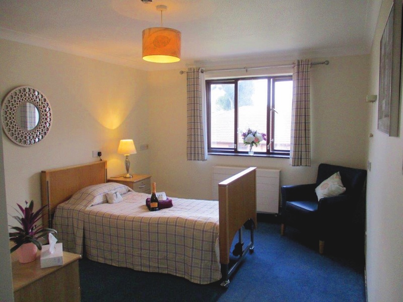 Bedroom at Moss View with champagne bottle on bed